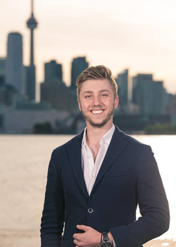 Artem outside with the Toronto skyline background