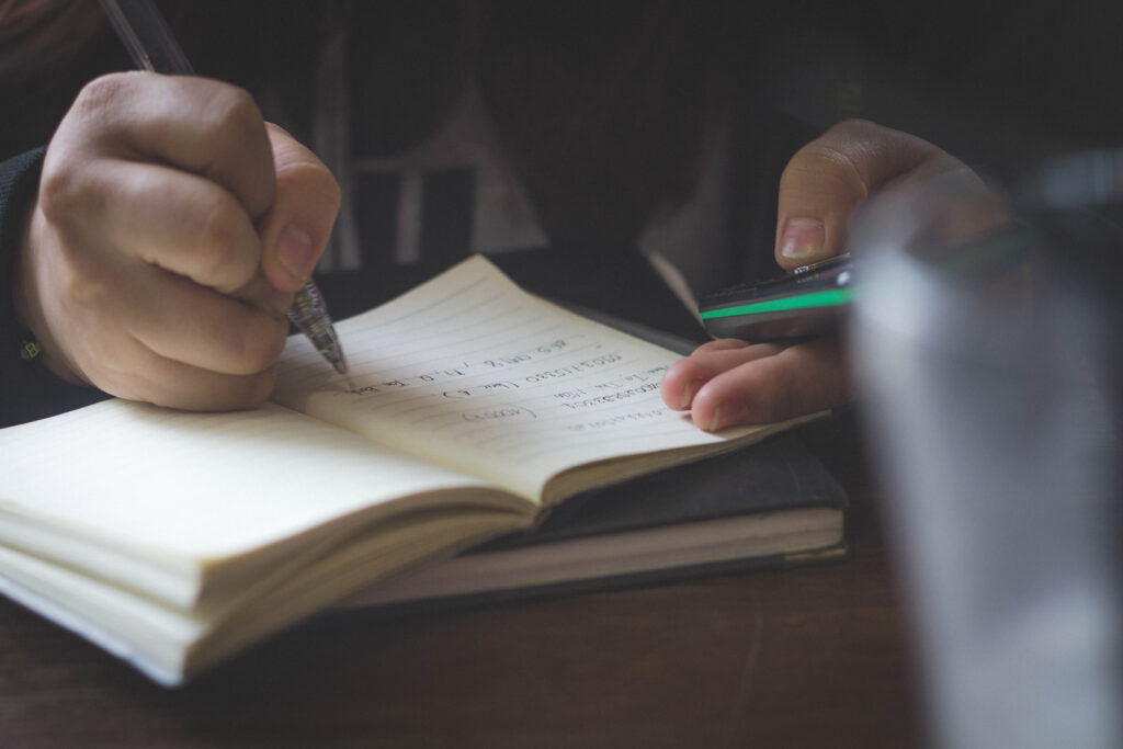 Close up of someone writing notes