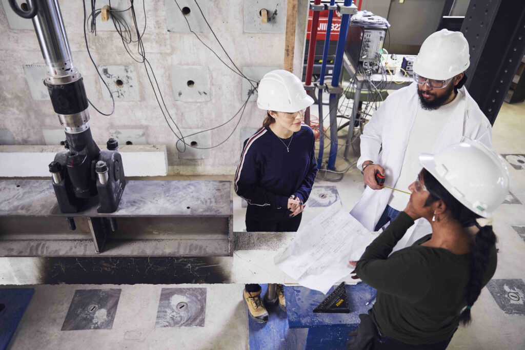 Three civil engineers in the high bay lab