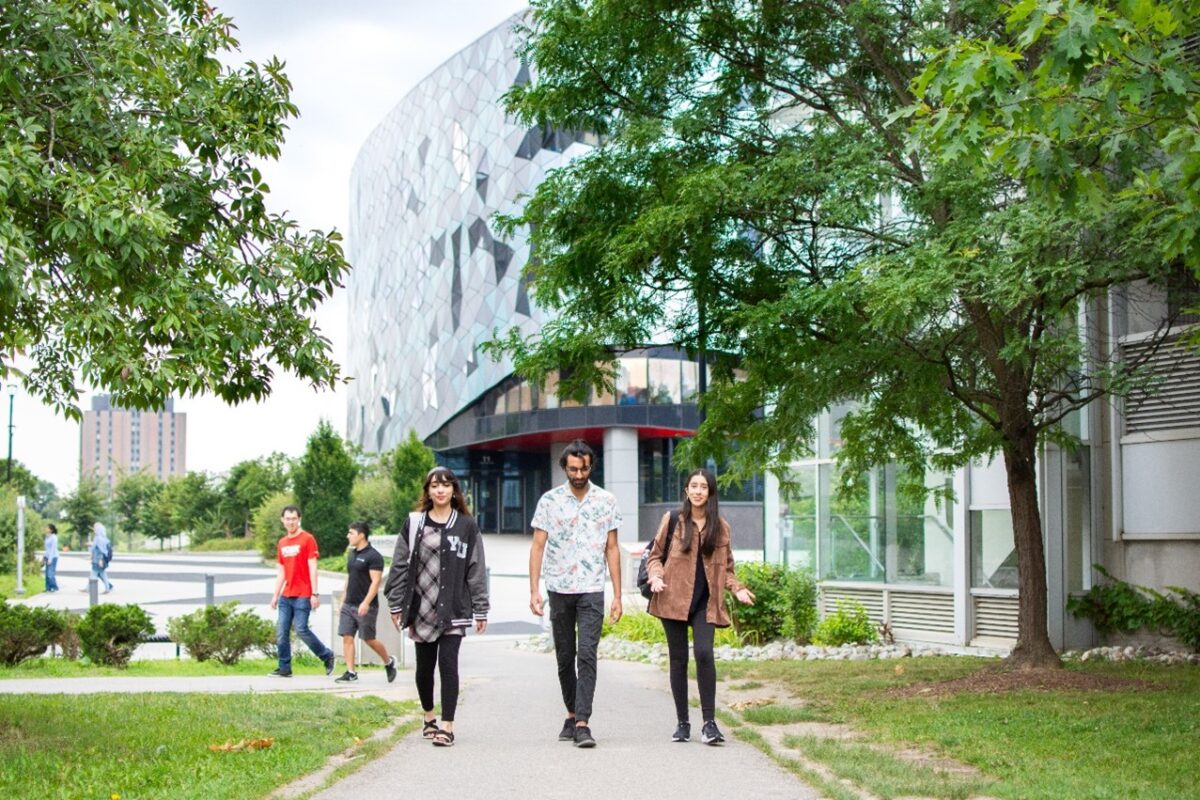 Three lassonde studens working on a path outside of the Bergeron Centre