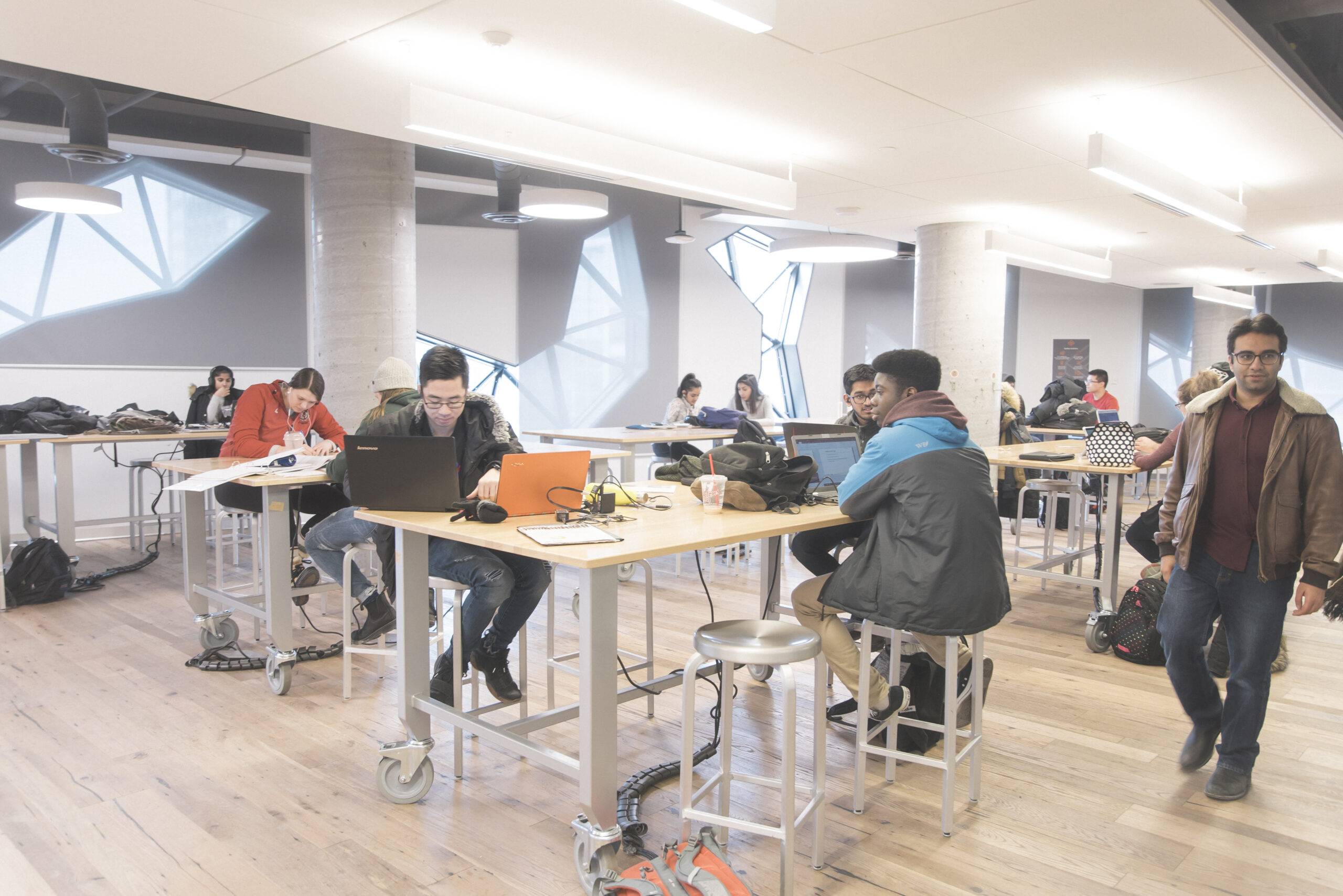 Hallway with students sitting at tables