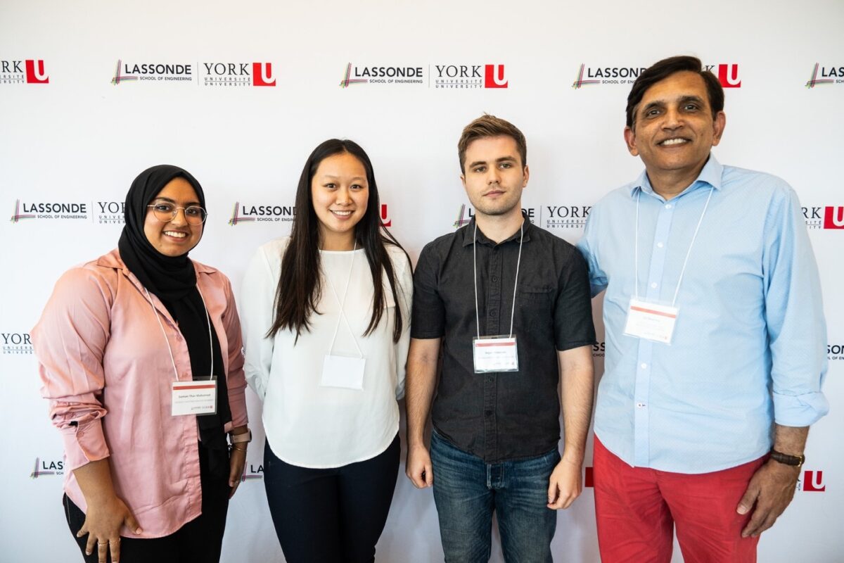 Professor Jit Sharma posing with recipients of the GeoSolv Capstone Innovation Award. Left to Right: Suman Thar Mohamed, Kathryn Chin, Dejan Mircevski, and Jit Sharma.