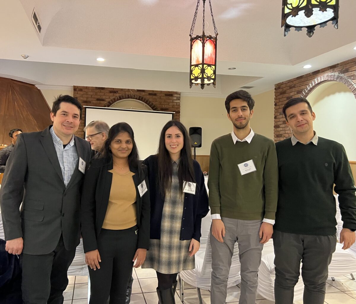 Professor Kamelia Atefi-Monfared with her current students at a conference event