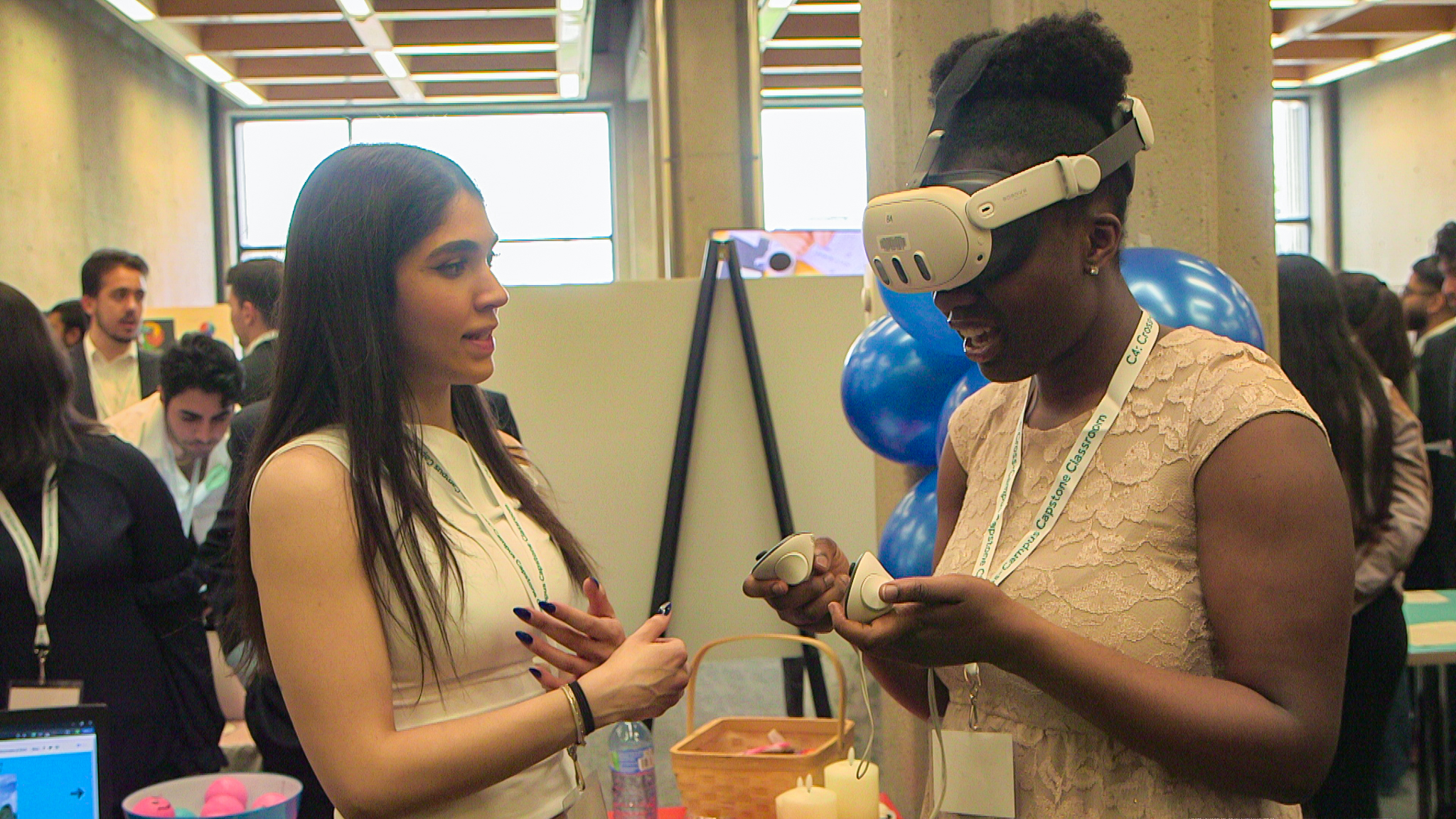 One person looking at another person with Virtual Reality headset.