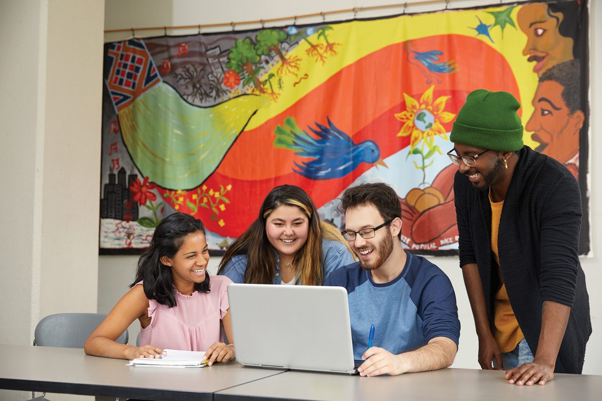 Students looking at a laptop