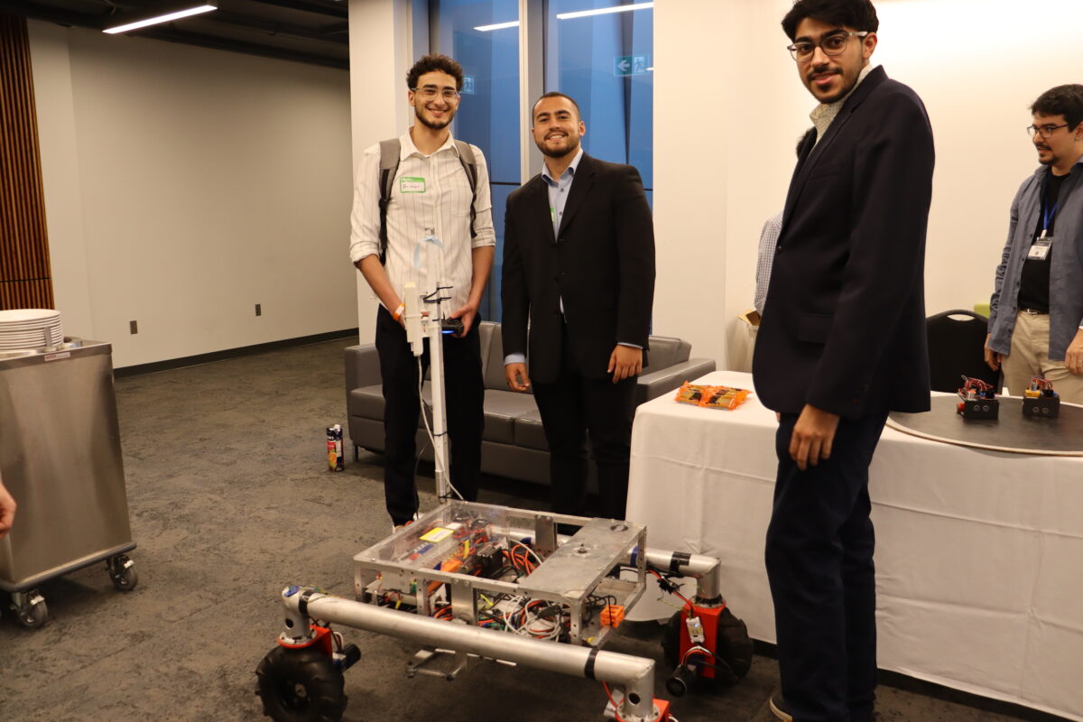 Students posing with robot