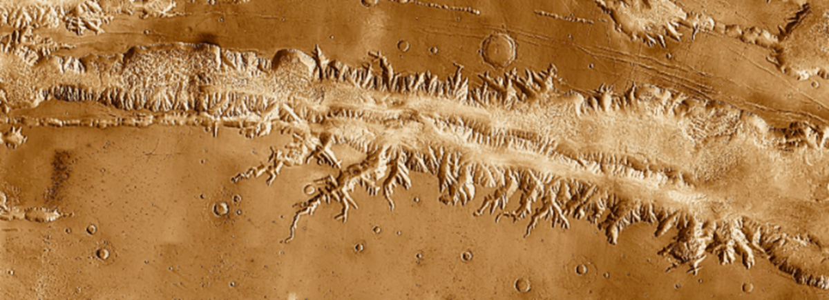 Ius Chasma, the largest region of Valles Marineris. Evidence of past water is seen in the rocks, including layered sediments close to the rim of the Chasma.