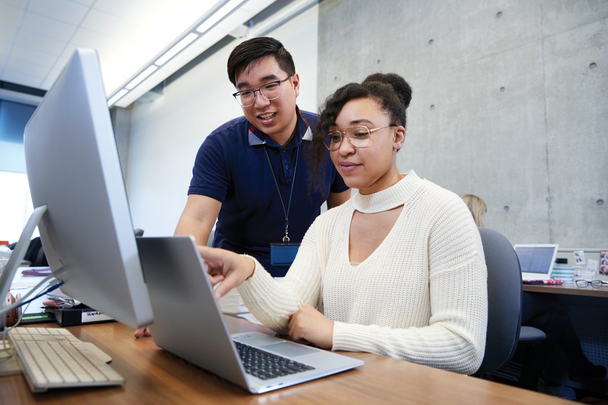 Man showing student something on the computer