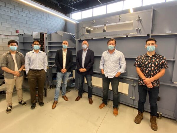 Group Photo, Professor Ronald Hanson with two of his students and aerodynamics and aeroacoustics experts from Aiolos and BMW in front of the wind tunnel at the Lassonde Research Center in late 2021