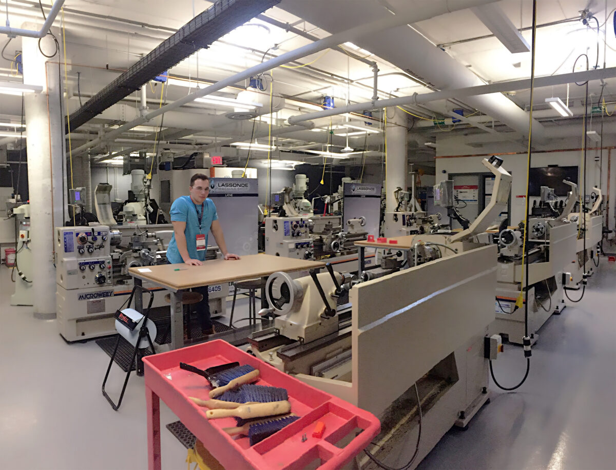 Lassonde Machine Shop, male worker standing working among machines