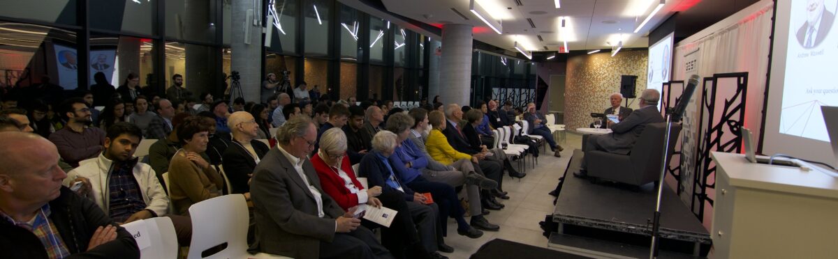 Dr. Allan Carswell hosts the Mercier Lecture, panoramic view of the stage and audience