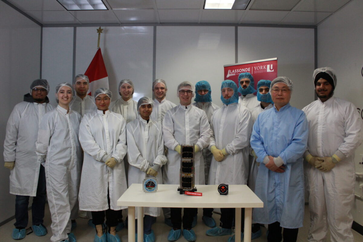 The ESSENCE CubeSat team saying goodbye to their satellite before it was shipped off for launch preparation