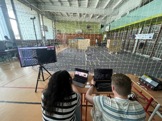 Ingredy Gabriela Gomes Carmo and Hunter Schofield at the final ICUAS UAV competition, receiving virtual technical support from teammate Mingfeng Yuan
