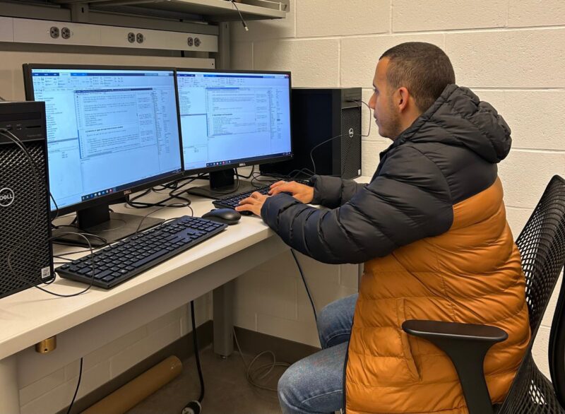 Ahmed Abdelaziz working at a smart grid lab, simulating cyberattacks and cybersecurity