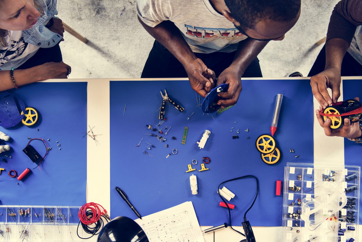 An aerial view of people working together in a mechanical lab