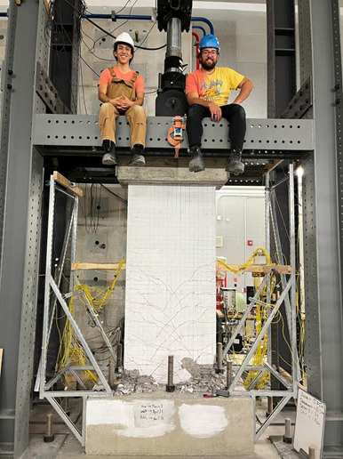 Austin Martins-Robalino (left) with fellow lab group member, Alessandro Paglia MASc., (right) after successful testing of traditional shear wall under simulated earthquake and gravity loading.