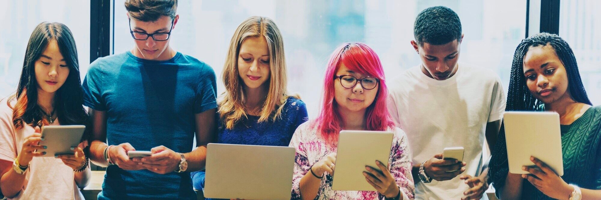 Diverse students with technologies.
