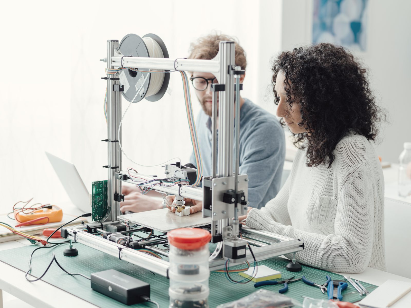 Engineering students using a 3D printer