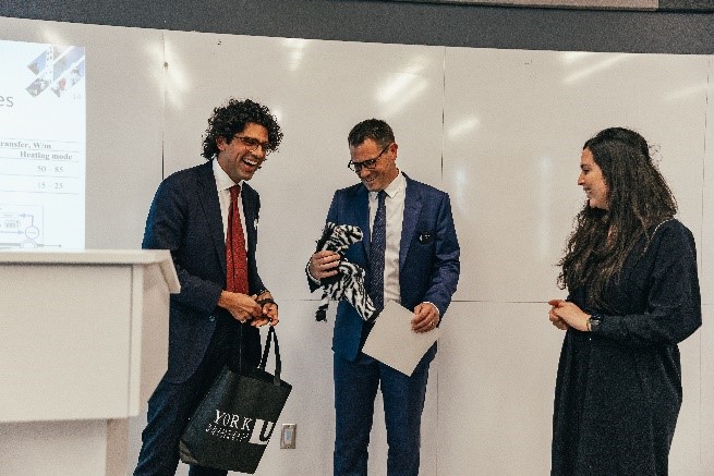 Dr. John McCartney receiving gifts and a certificate of appreciation