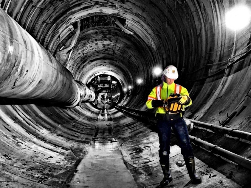 Josephine collecting data in a tunnel using a LiDAR scanning tool.