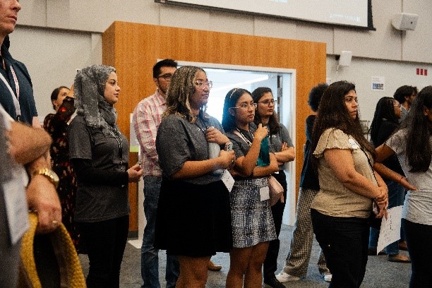 Event attendees listening to a student presentation at Bringing STEM to Life Symposium