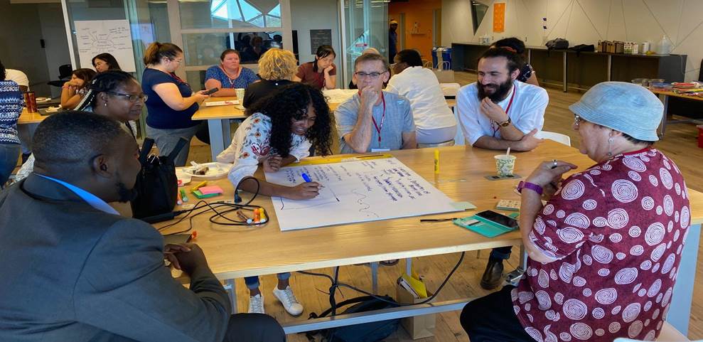 Diverse group of teachers share their ideas during a poster session