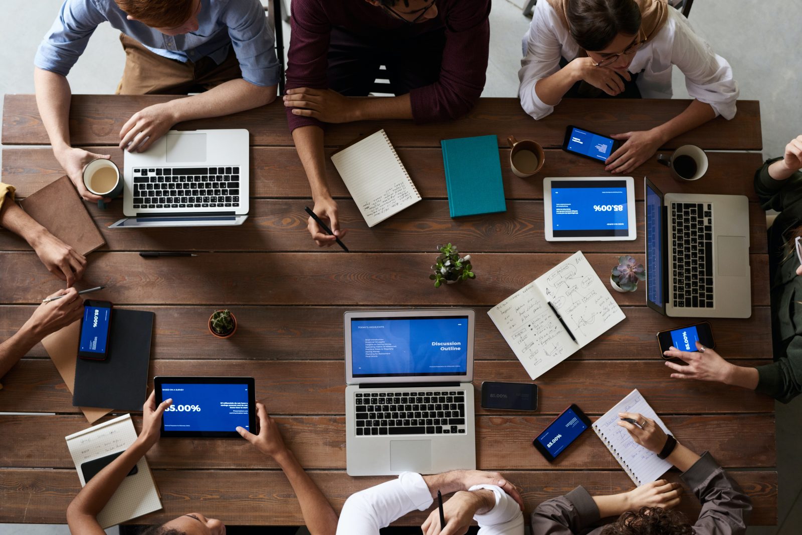 Folks around a table with their laptops