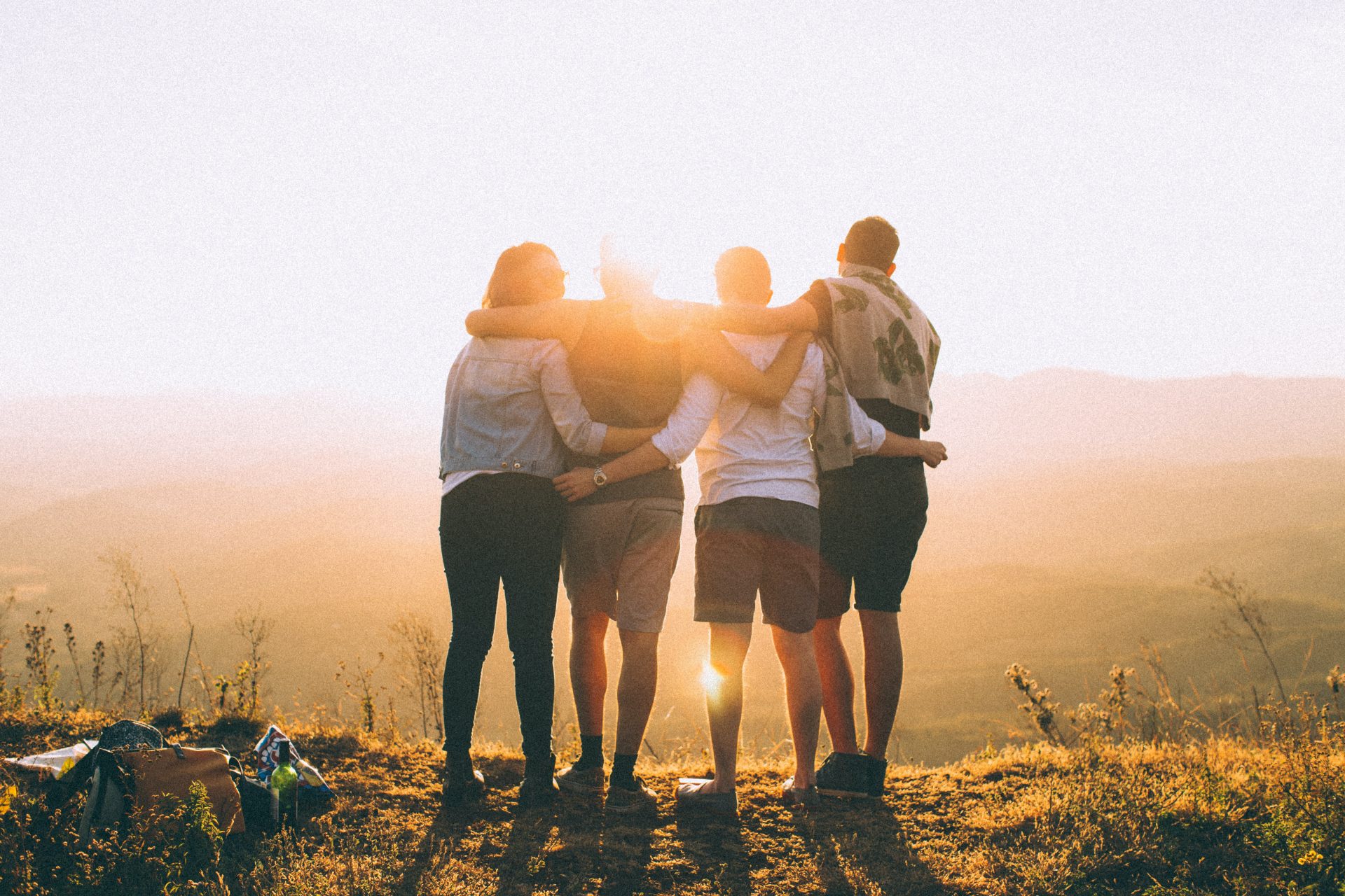 Four young people smiling in the sun