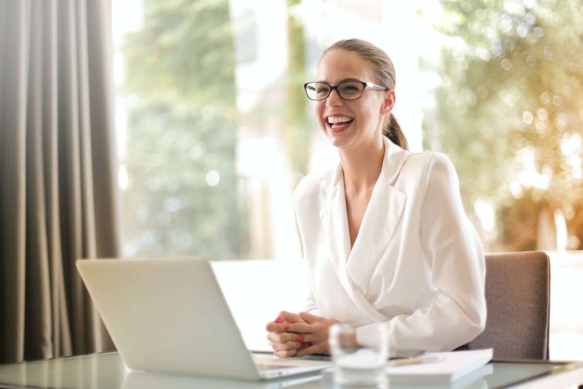 women smiling in front of laptop