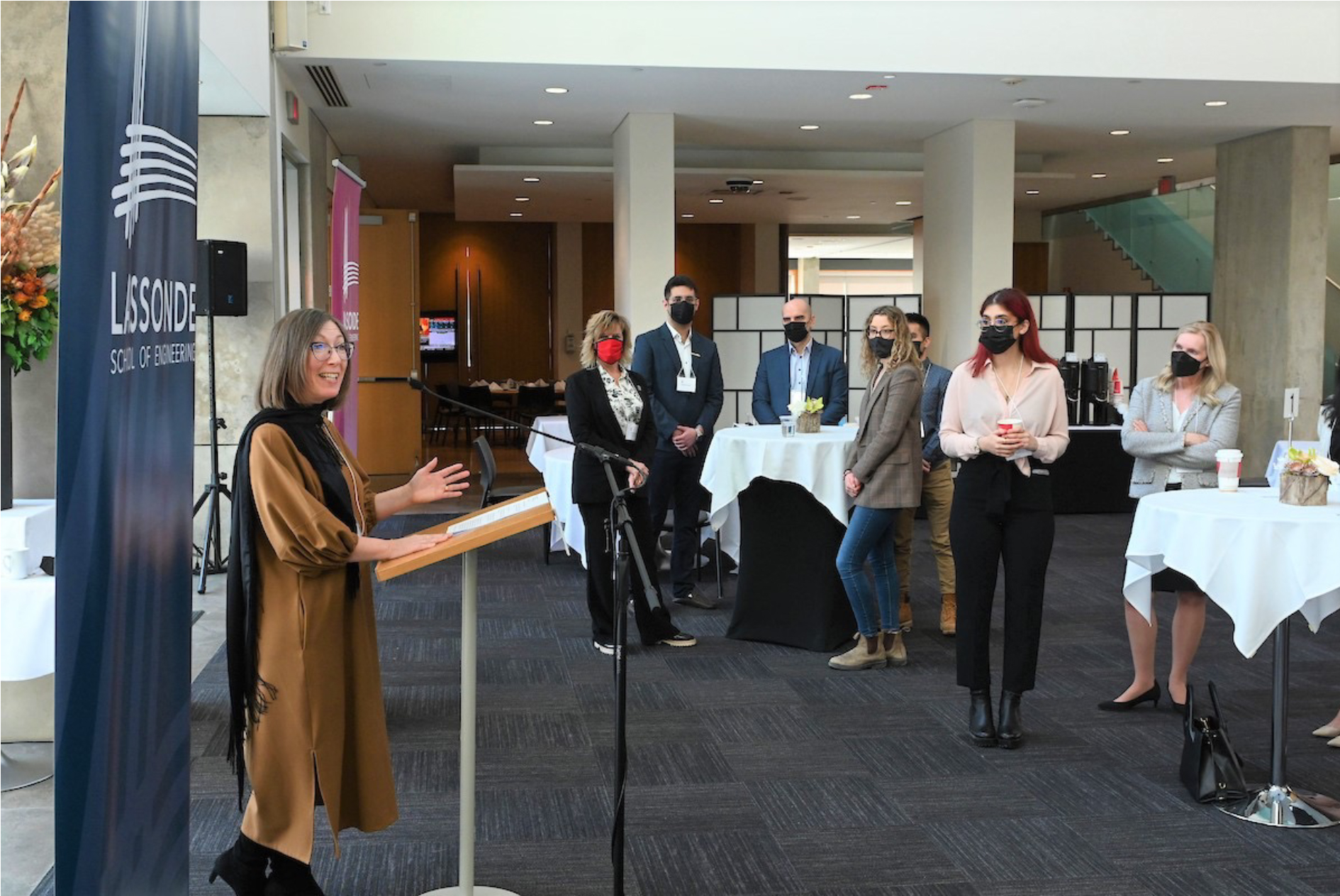 A photo of a woman at a podium addressing a group of people