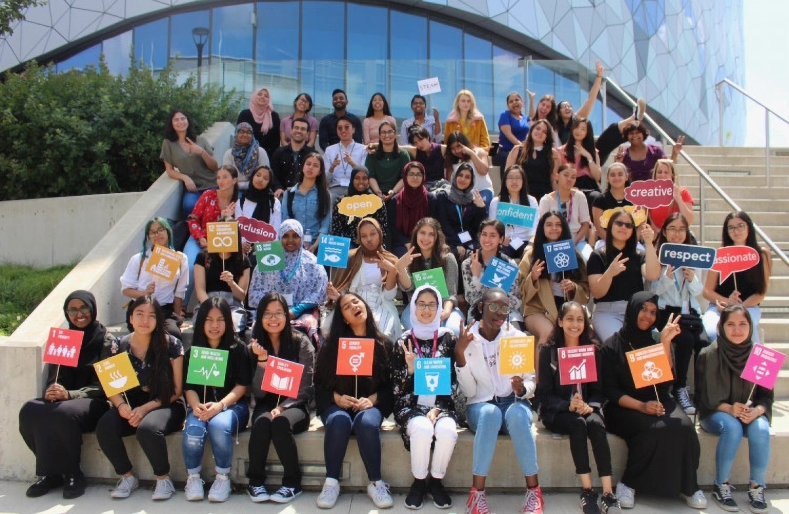 A group of students holding UN placards outside of Bergeron