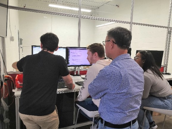 SDCN Lab team members discussing technical schemes with Dr. Gilbert, engineer at Quanser Consulting inc.
